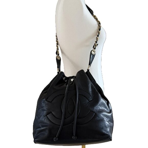 CHANEL Handbags - CHANEL | CC Logo Embossed Black Lambskin Drawstring Bucket Bag